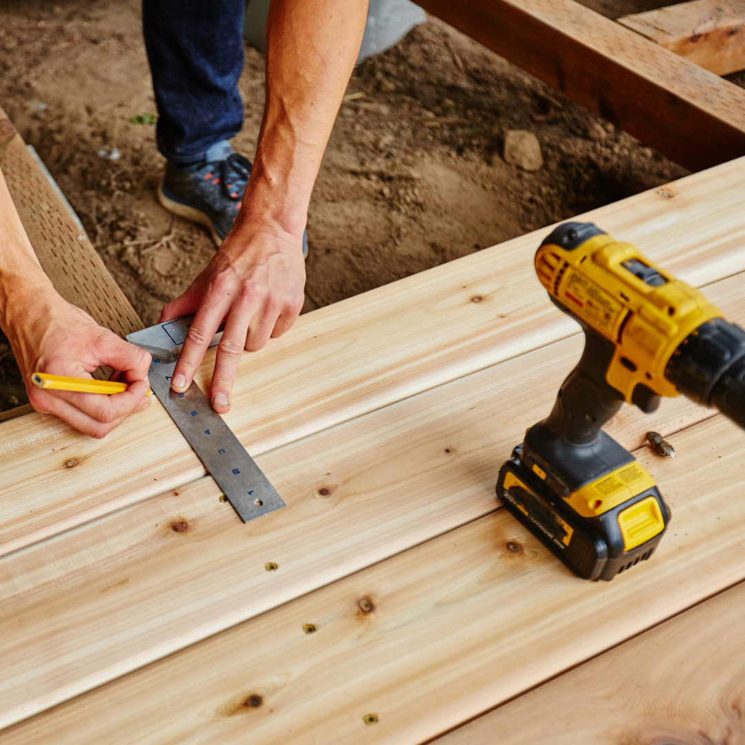 Man laying a decking with the best decking screws