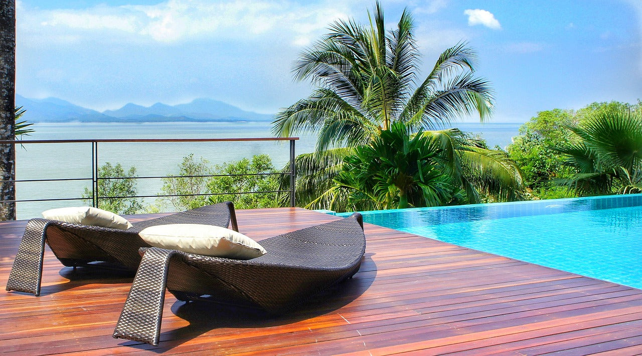 Two chairs on new deck beside pool overlooking ocean