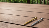 Generic coated deck screw beside an Eagle Claw stainless steel deck screw on pressure-treated decking