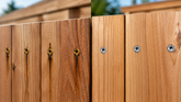 Eagle Claw stainless steel deck screws compared with Deck Mate coated screws on a cedar fence