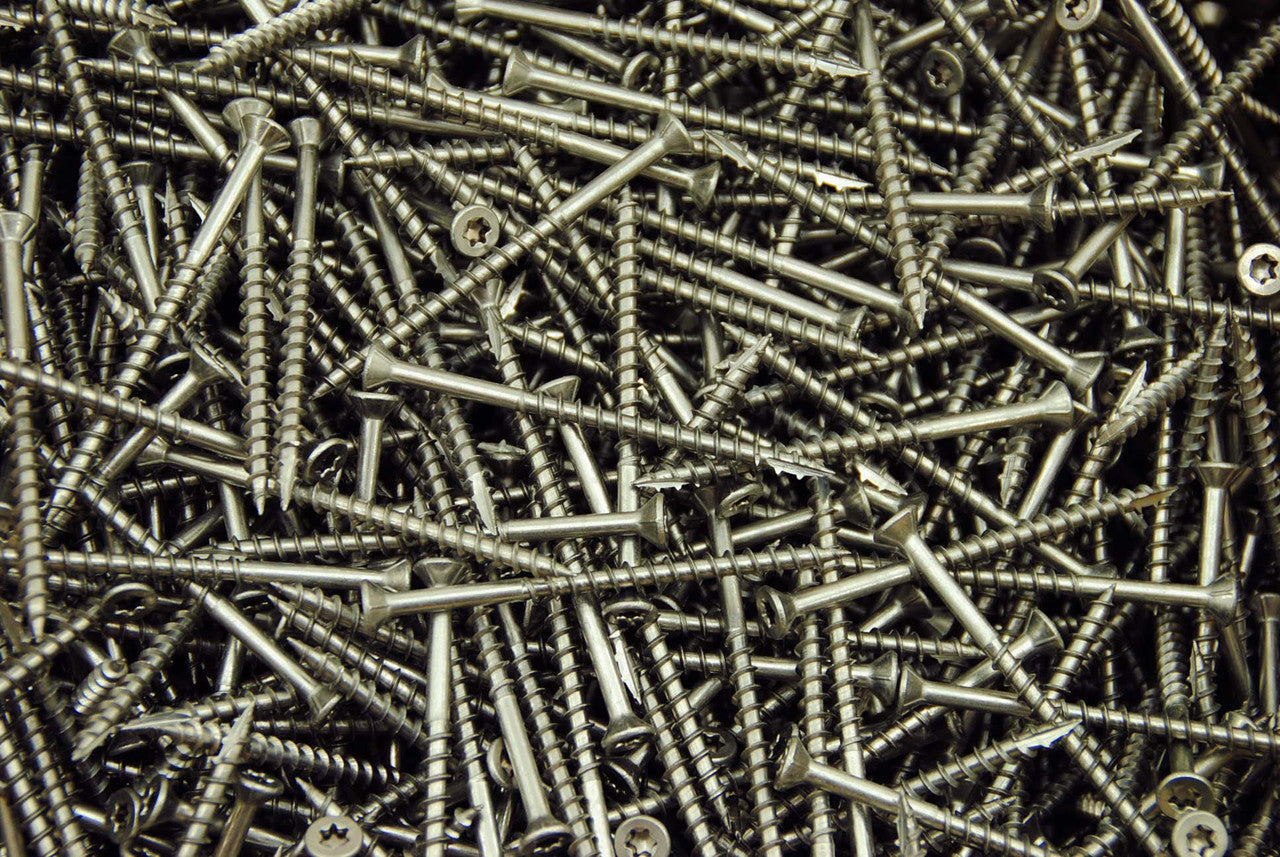 3" stainless steel torx drive screws in a large pile