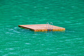 floating dock in a lake of green-blue water