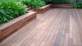 Wooden deck with built-in benches and greenery