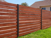 Wooden fence with horizontal slats in a residential area